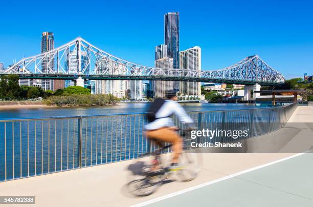 cyclist, brisbane city. australia - bicycle lane stock pictures, royalty-free photos & images