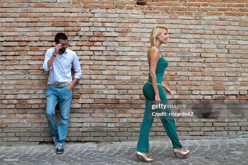Man Standing In A Street And Looking At A Woman