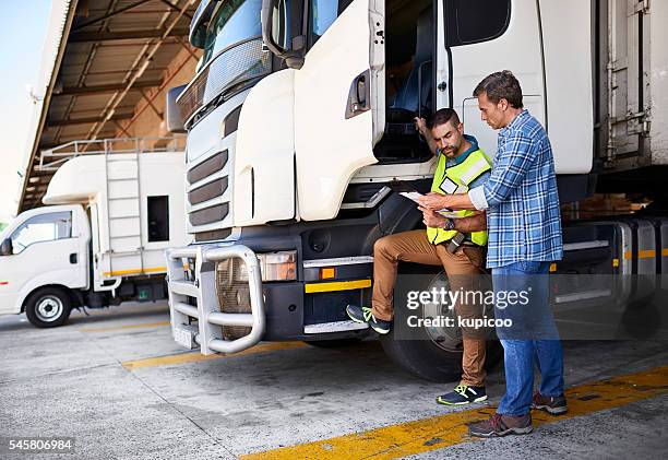 checking the manifest one last time - trucker stock pictures, royalty-free photos & images