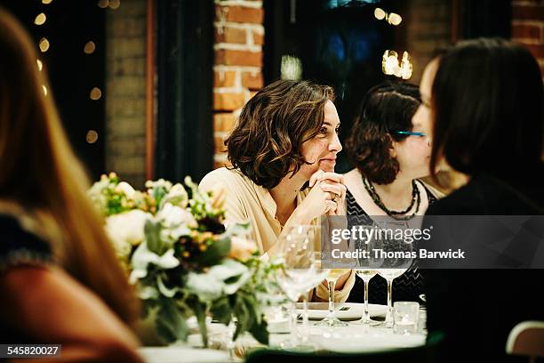 smiling woman talking with friends during dinner - formal dining stock pictures, royalty-free photos & images