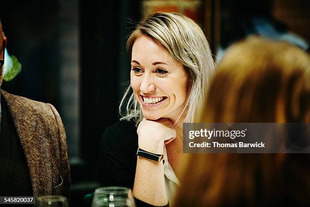 smiling woman with friends at dinner party - männerabend stock-fotos und bilder