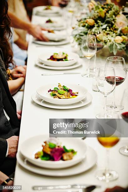 guests being served plates of food during dinner - pair stock pictures, royalty-free photos & images