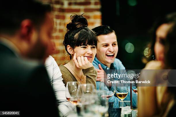 woman in conversation with friends during dinner - flat party photos et images de collection