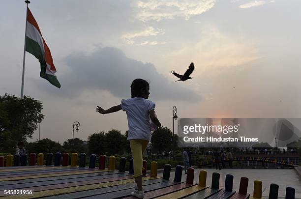 Child enjoys pleasant weather at CP, Center Park, on July 9, 2016 in New Delhi, India. Sudden rains brought respite for people in capital after a hot...