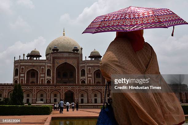 Tourists enjoy pleasant weather at Humayun Tomb, on July 9, 2016 in New Delhi, India. Sudden rains brought respite for people in capital after a hot...