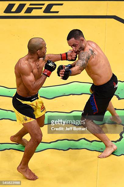Jose Aldo of Brazil punches Frankie Edgar in their interim featherweight championship bout during UFC 200 event at T-Mobile Arena on July 9, 2016 in...