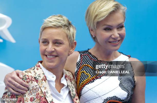 Actress and television host Ellen DeGeneres and her partner Australian born actress Portia de Rossi pose for photographers as they arrive to attend...