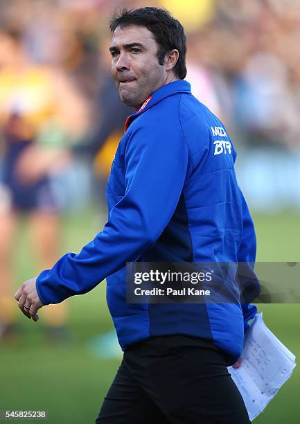 Brad Scott, coach of the Kangaroos walks from th eteam huddle after the three quarter time break during the round 16 AFL match between the West Coast...