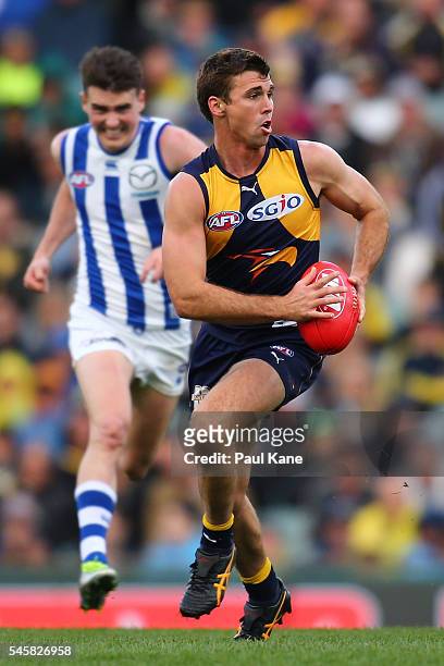 Jamie Cripps of the Eagles looks to pass the ball during the round 16 AFL match between the West Coast Eagles and the North Melbourne Kangaroos at...