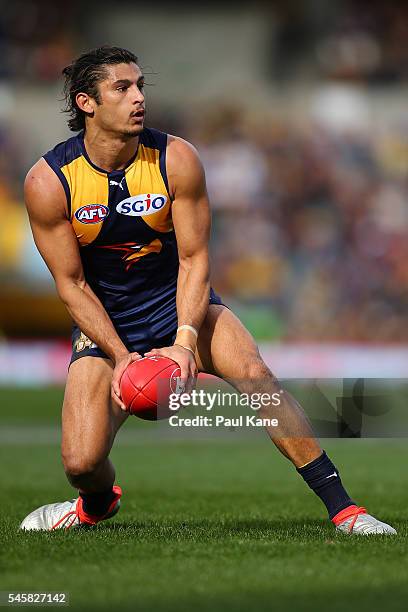 Sharrod Wellingham of the Eagles looks to pass the ball during the round 16 AFL match between the West Coast Eagles and the North Melbourne Kangaroos...