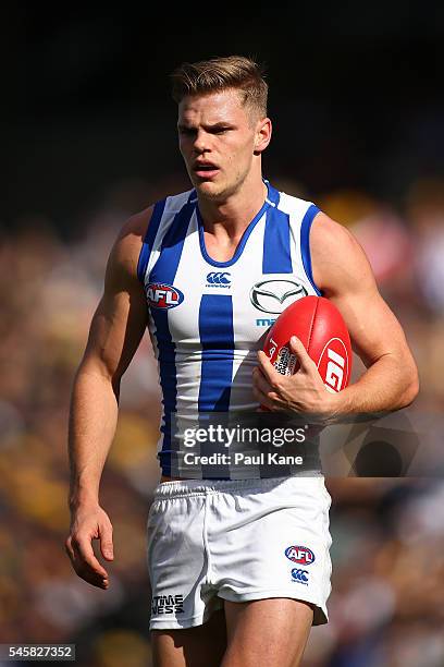 Mason Wood of the Kangaroos walks back to his mark for a kick on goal during the round 16 AFL match between the West Coast Eagles and the North...