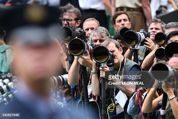 Photographers aim their lenses at the royal box on centre court before the men's singles final match on the last day of the 2016 Wimbledon...