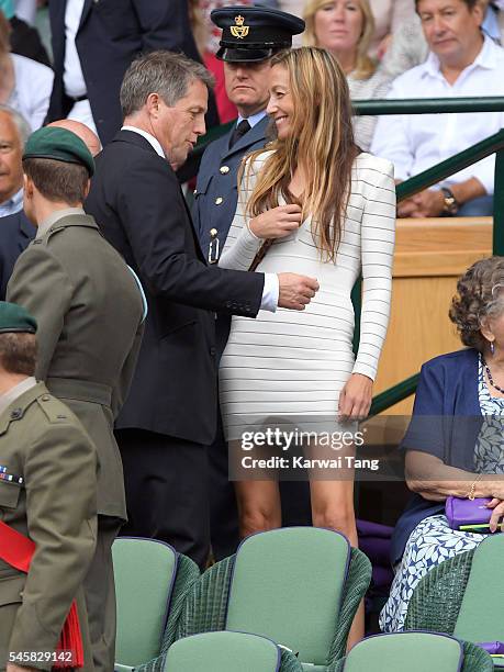 Hugh Grant and Anna Eberstein attend the Men's Final of the Wimbledon Tennis Championships between Milos Raonic and Andy Murray at Wimbledon on July...