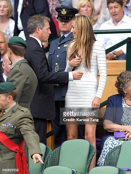 Hugh Grant and Anna Eberstein attend the Men's Final of the Wimbledon Tennis Championships between Milos Raonic and Andy Murray at Wimbledon on July...