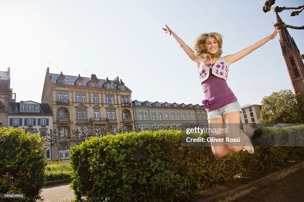 Young woman jumping at university