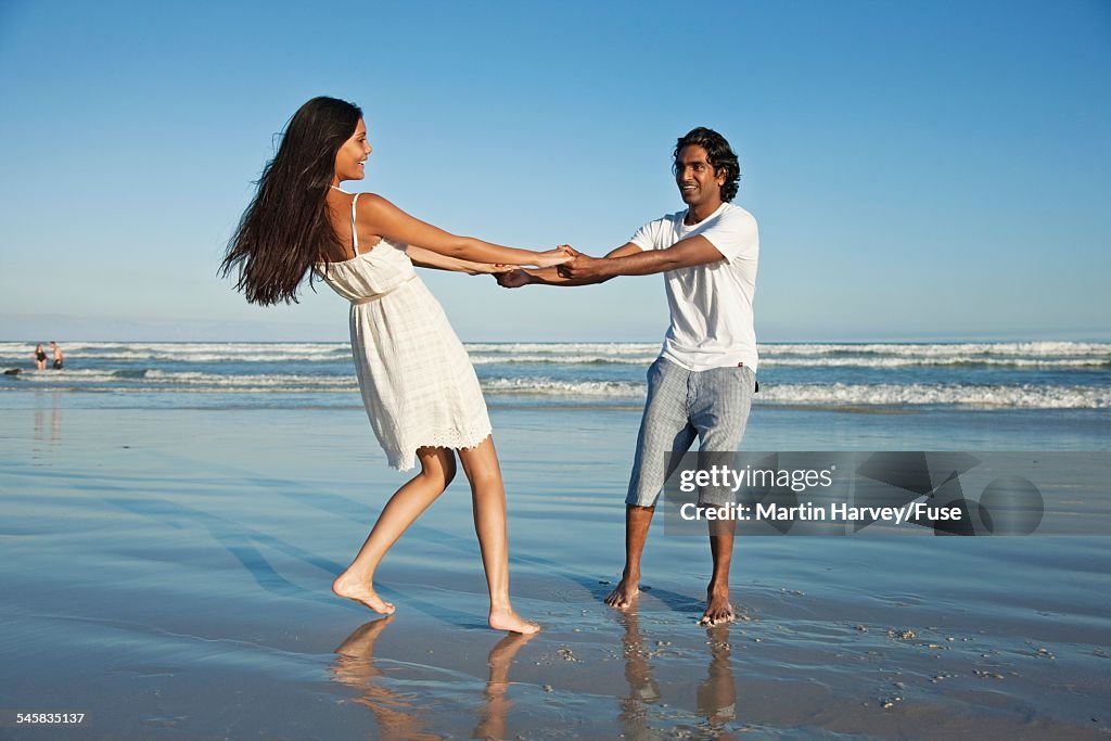 Couple playing on the beach