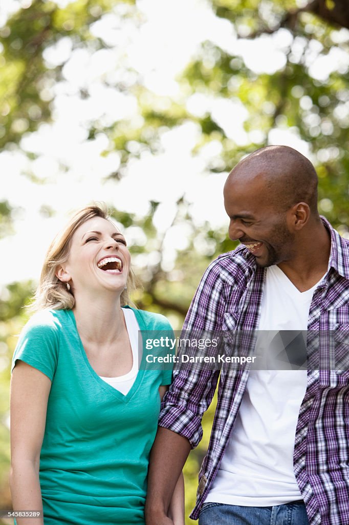 Young couple taking a walking in a park