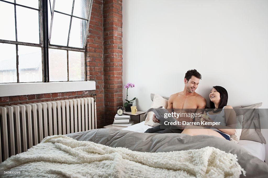 Young couple relaxing in bed