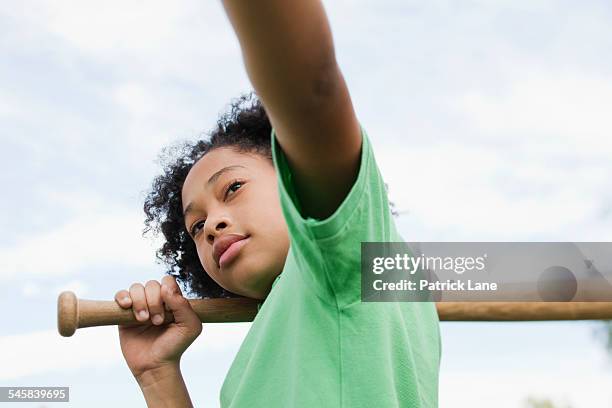 girl (10-12) holding baseball bat - girl 10 12 stock pictures, royalty-free photos & images