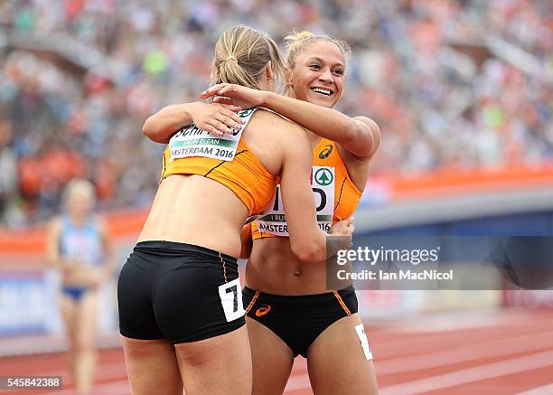 Dafne Schippers of The Netherlands and team mate Naomi Sedney celebrate after winning gold in the final of the womens 4x100m relay on day five of The...