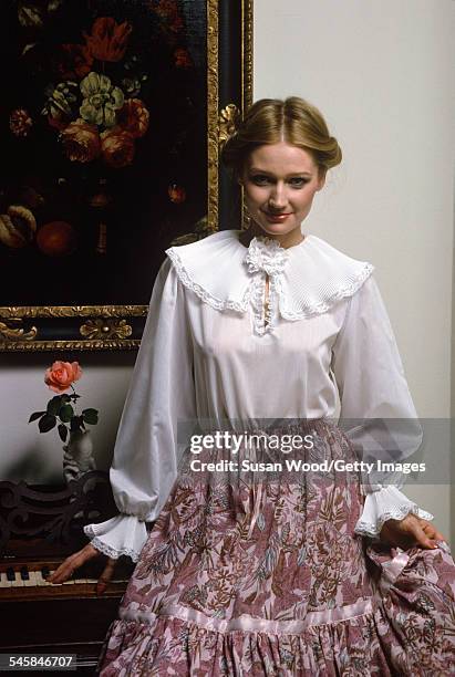 Portrait of an unidentified model in a Victorian-style blouse as she poses in front of a piano, December 1977. The photo was taken as part of a...