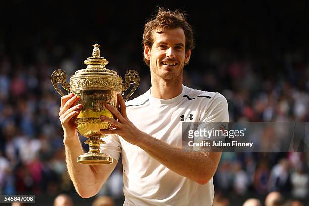Andy Murray of Great Britain lifts the trophy following victory in the Men's Singles Final against Milos Raonic of Canada on day thirteen of the...