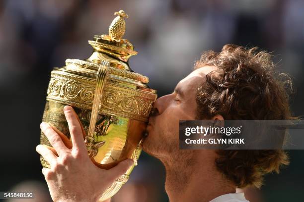 Britain's Andy Murray poses with the winner's trophy after his men's singles final victory over Canada's Milos Raonic on the last day of the 2016...