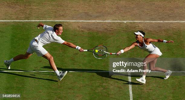 Heather Watson of Great Britain and Henri Kontinen of Finland both stretch to return the ball during the Mixed Doubles Final against Robert Farah of...