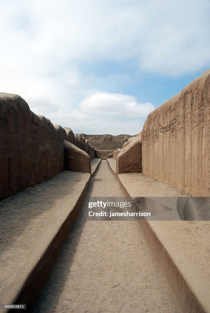 Peru, Trujillo, Chan Chan, View along walkway leading between adobe walls