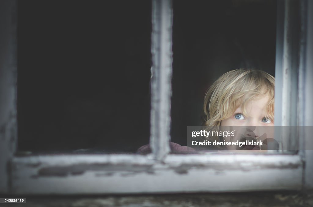 Boy looking through a window