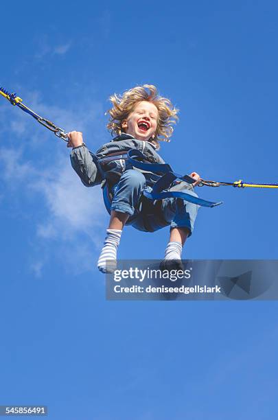 boy on a bungee swing laughing - bungee jump - fotografias e filmes do acervo