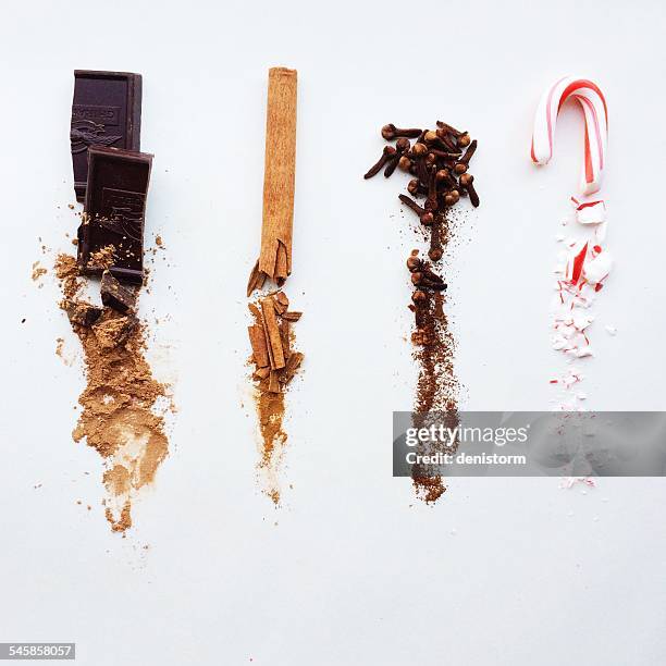 chocolate, cinnamon, cloves, and candy cane, whole at top, crushed below - cinnamon stock pictures, royalty-free photos & images