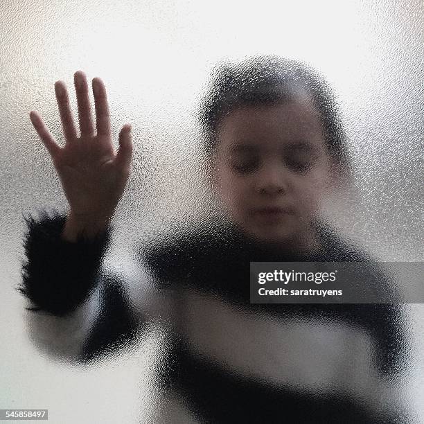 girl touching frosted glass - frosted glass ストックフォトと画像