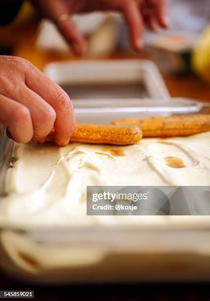 italy, hand of man preparing tiramisu - tiramisu stock pictures, royalty-free photos & images