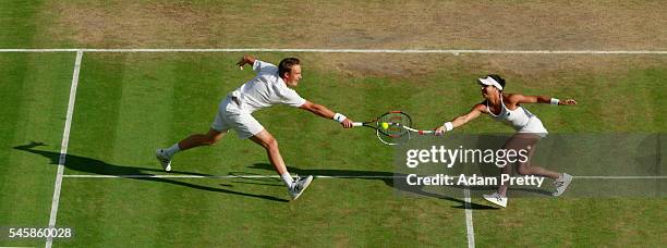 Heather Watson of Great Britain and Henri Kontinen of Finland both stretch to return the ball during the Mixed Doubles Final against Robert Farah of...