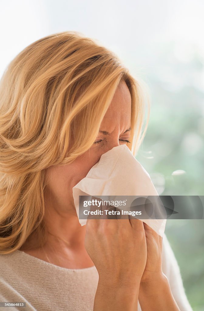 USA, New Jersey, Woman blowing nose