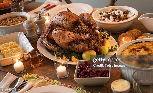 dining table filled with thanksgiving food - thanksgiving holiday bildbanksfoton och bilder
