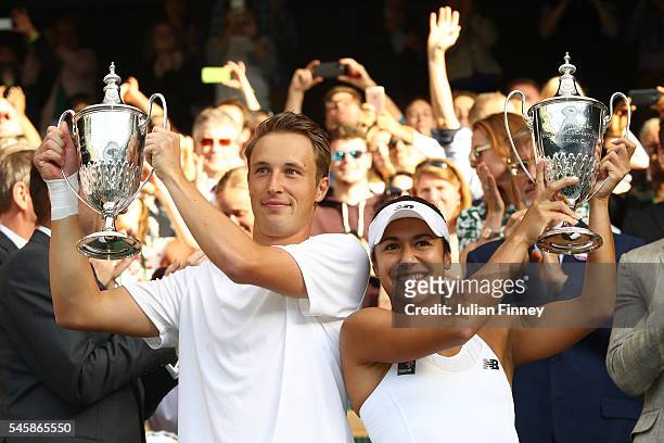 Heather Watson of Great Britain and Henri Kontinen of Finland lift their trophies following victory in the Mixed Doubles Final against Robert Farah...