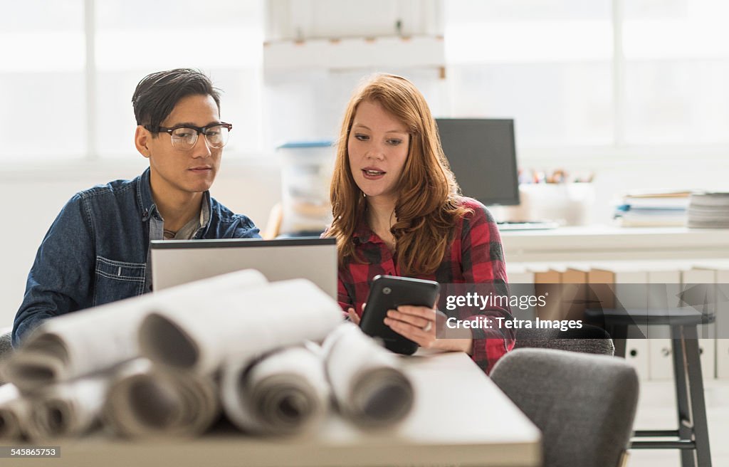 USA, New Jersey, Businesswoman and businessman working together in office