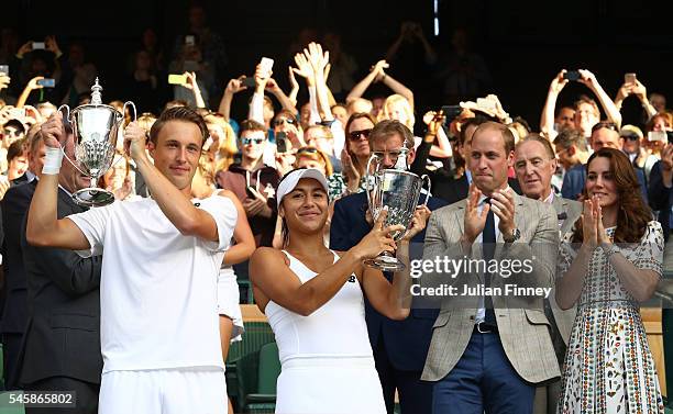 Heather Watson of Great Britain and Henri Kontinen of Finland lift their trophies as Prince William, HRH The Duke of Cambridge and Catherine, HRH The...