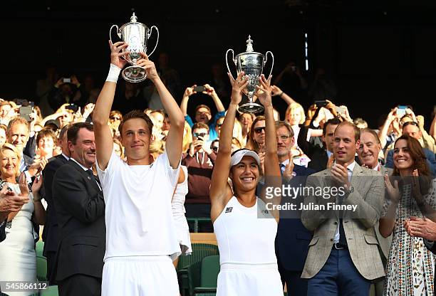 Heather Watson of Great Britain and Henri Kontinen of Finland lift their trophies as Prince William, HRH The Duke of Cambridge and Catherine, HRH The...