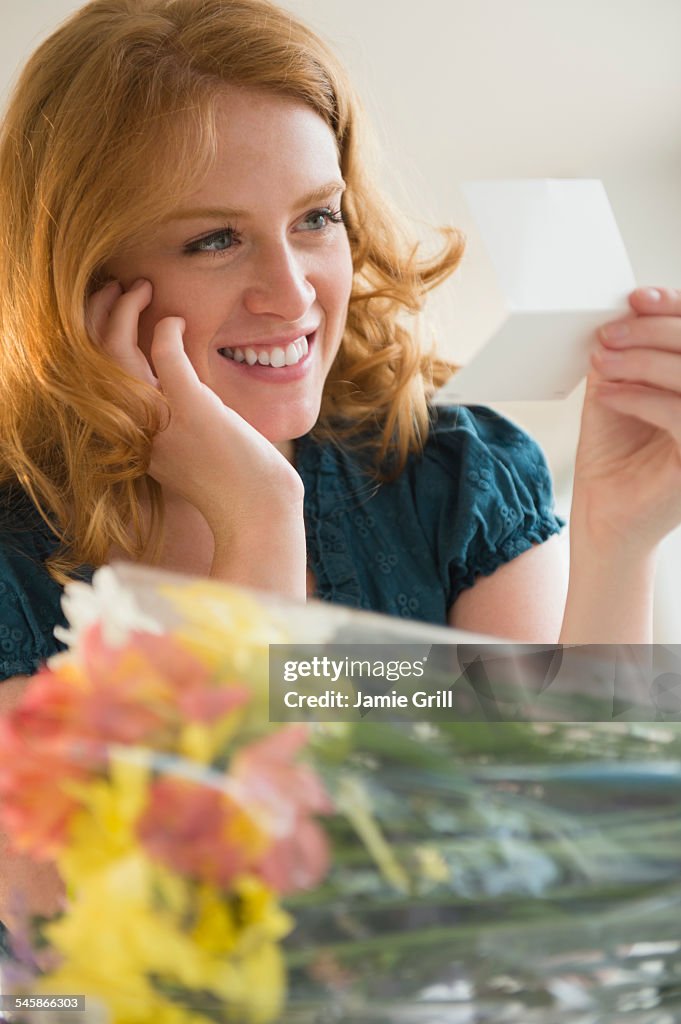 USA, New Jersey, Young woman reading postcard
