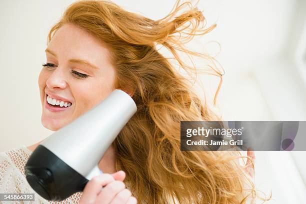 usa, new jersey, woman blow drying hair - hair dryer stock pictures, royalty-free photos & images