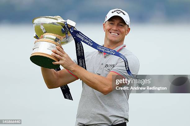 Alex Noren of Sweden poses with the trophy after claiming a one shot victory during the final round of the AAM Scottish Open at Castle Stuart Golf...