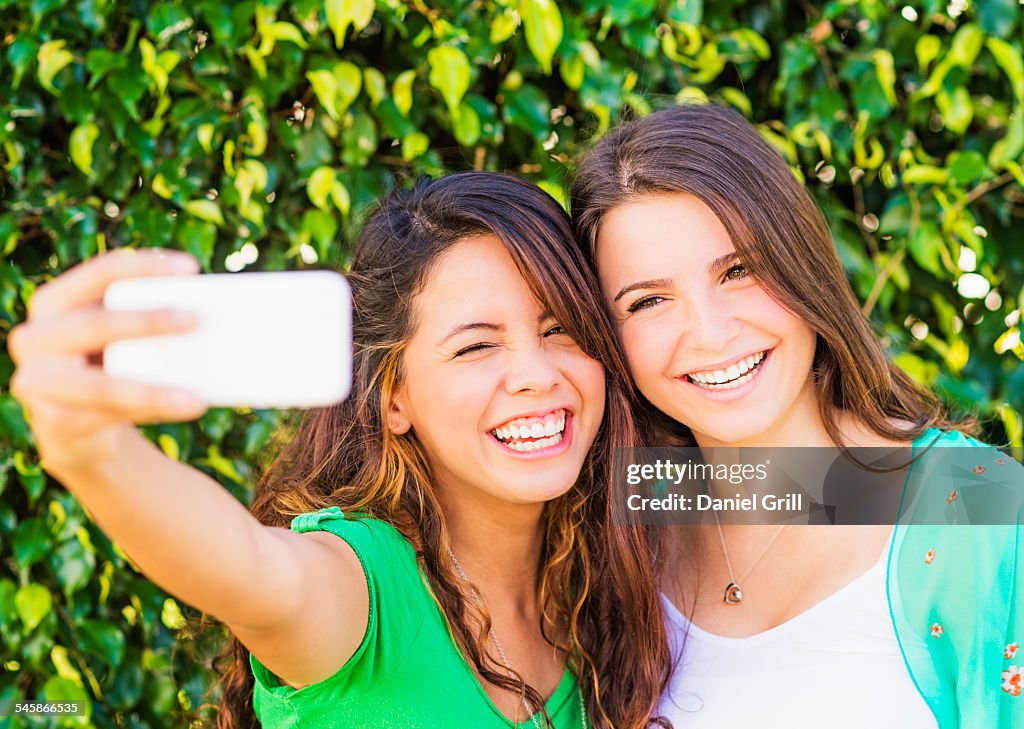 USA, Jupiter, Florida, Portrait of female friends (14-15) making selfie