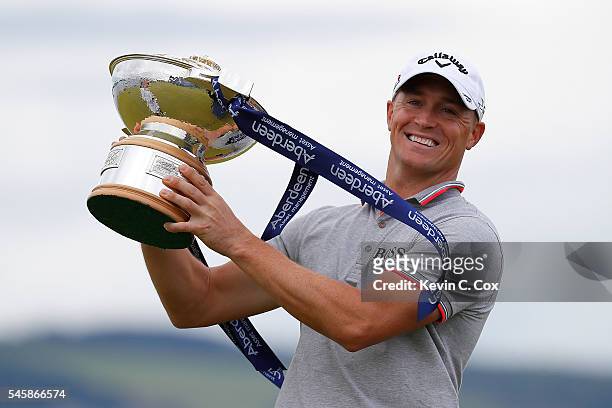 Alex Noren of Sweden poses with the trophy after claiming a one shot victory during the final round of the AAM Scottish Open at Castle Stuart Golf...