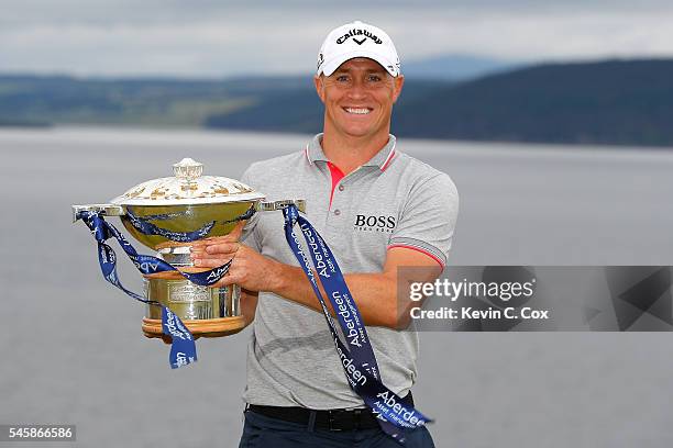 Alex Noren of Sweden poses with the trophy after claiming a one shot victory during the final round of the AAM Scottish Open at Castle Stuart Golf...