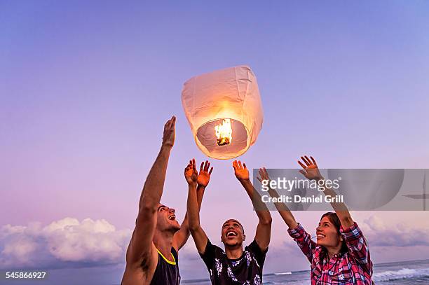 usa, florida, jupiter, young people with illuminated lantern on beach - jupiter florida fotografías e imágenes de stock