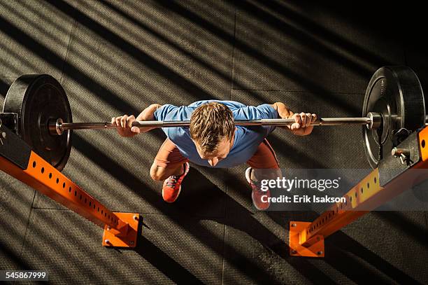 usa, california, ladera ranch, mature man doing squats - hockend stock-fotos und bilder