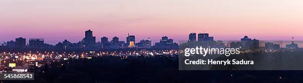 canada, manitoba, winnipeg, purple cityscape at sunset - winnipeg stock pictures, royalty-free photos & images